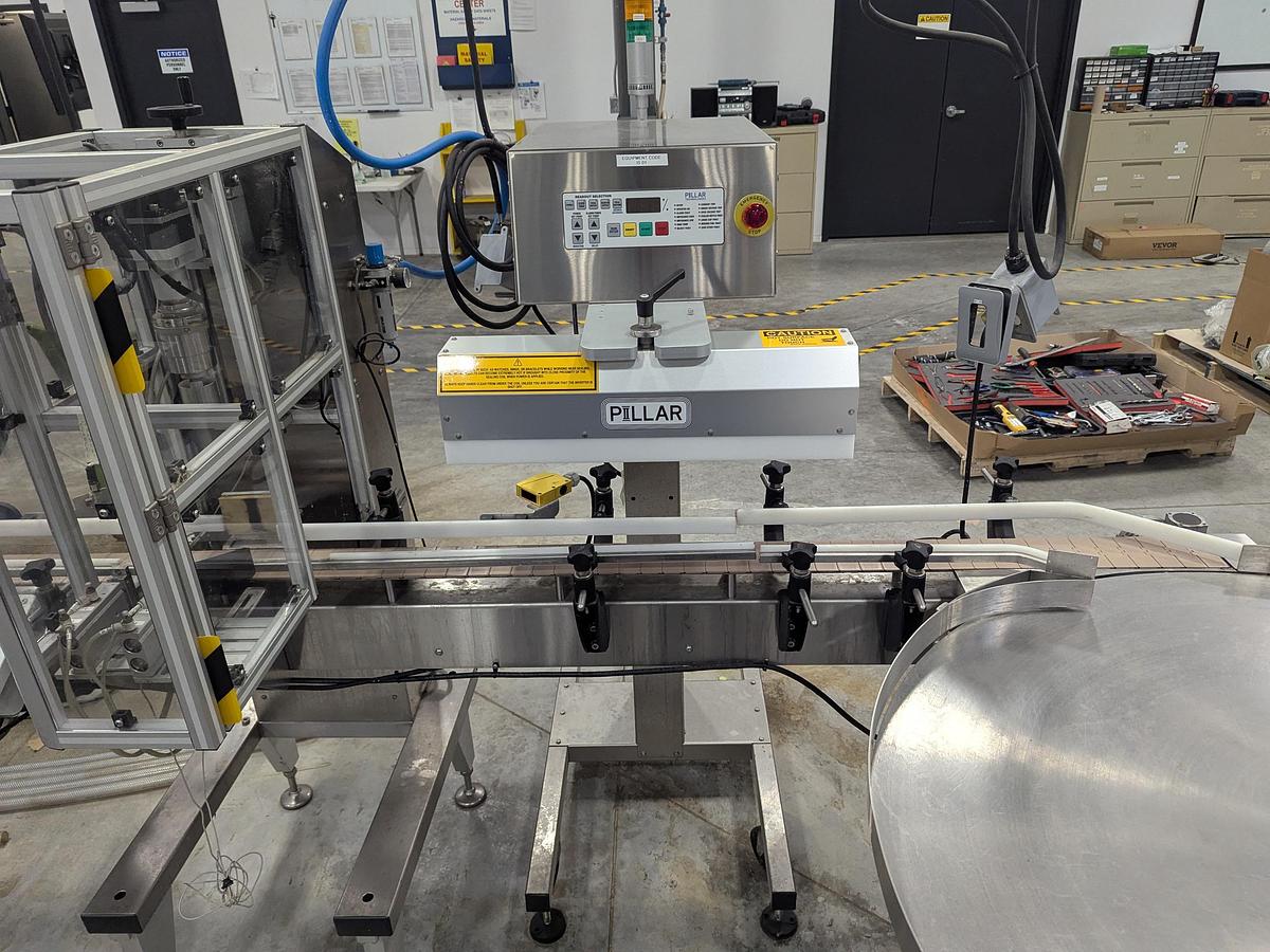 Used Aesus 6-Head Filling Line with Descrambler. Labeler, Filler, Capper, Induction Sealer & Accumulation Table