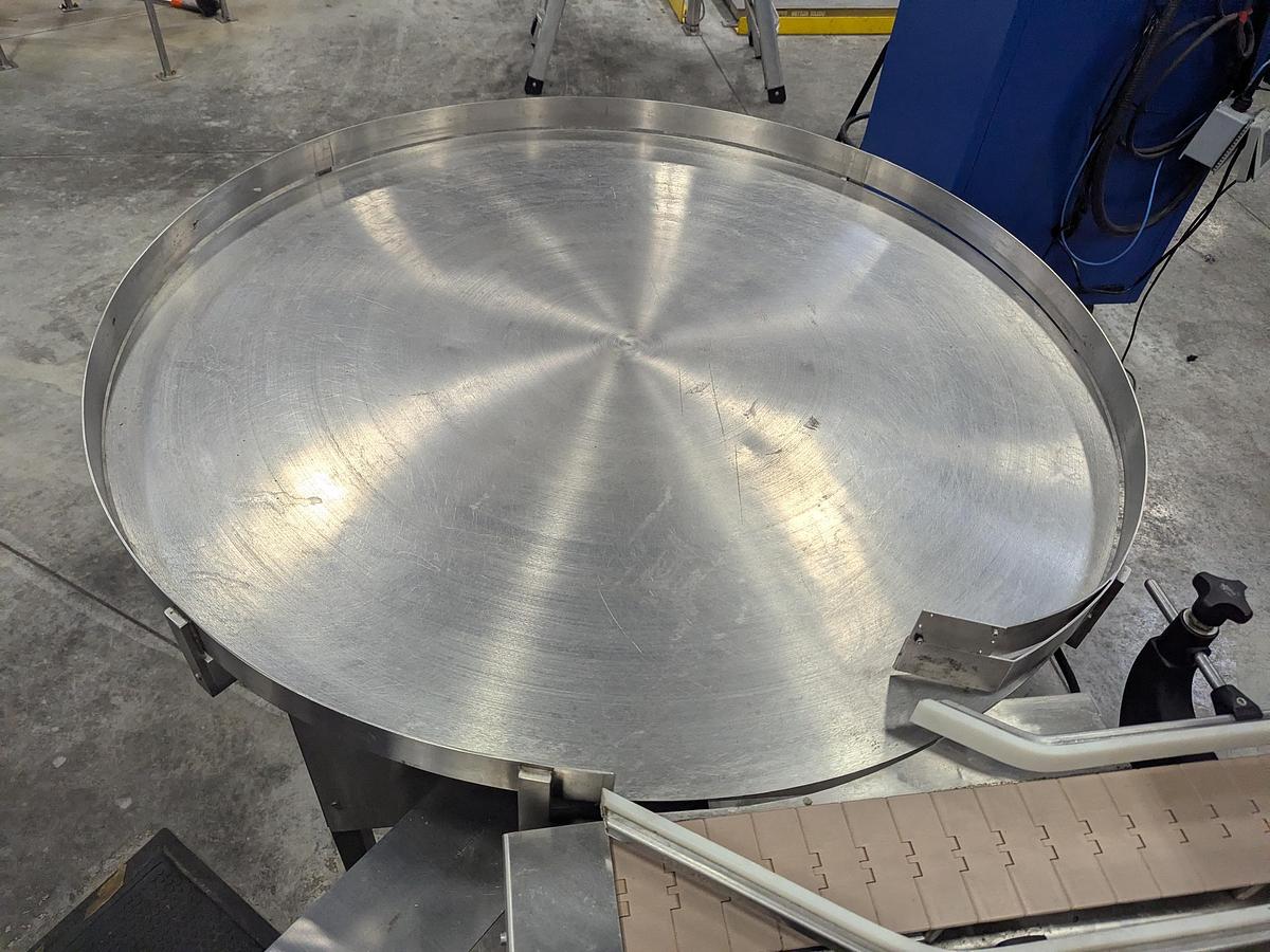 Used Aesus 6-Head Filling Line with Descrambler. Labeler, Filler, Capper, Induction Sealer & Accumulation Table