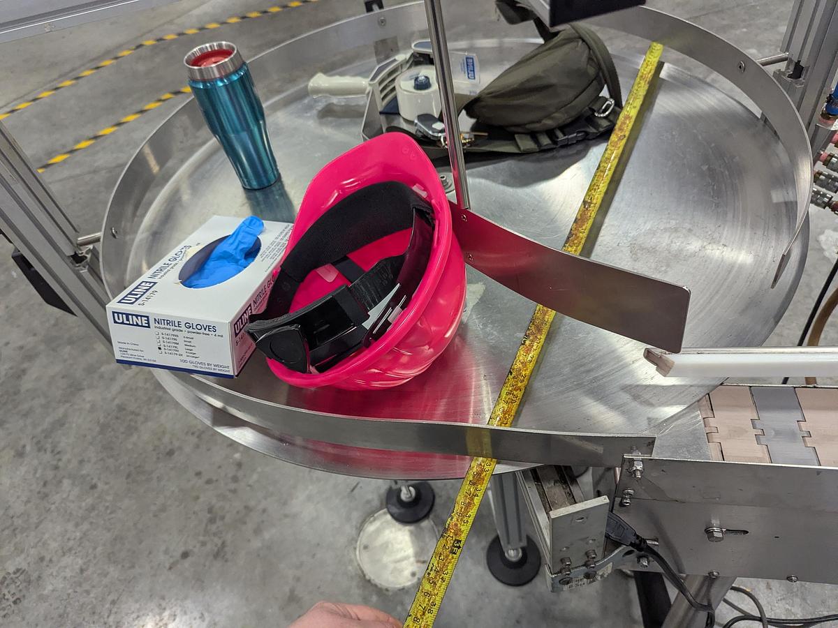 Used Aesus 6-Head Filling Line with Descrambler. Labeler, Filler, Capper, Induction Sealer & Accumulation Table