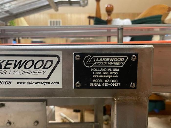 Used Lakewood Clamshell Filler with Infeed Conveyor & Accumulation Table