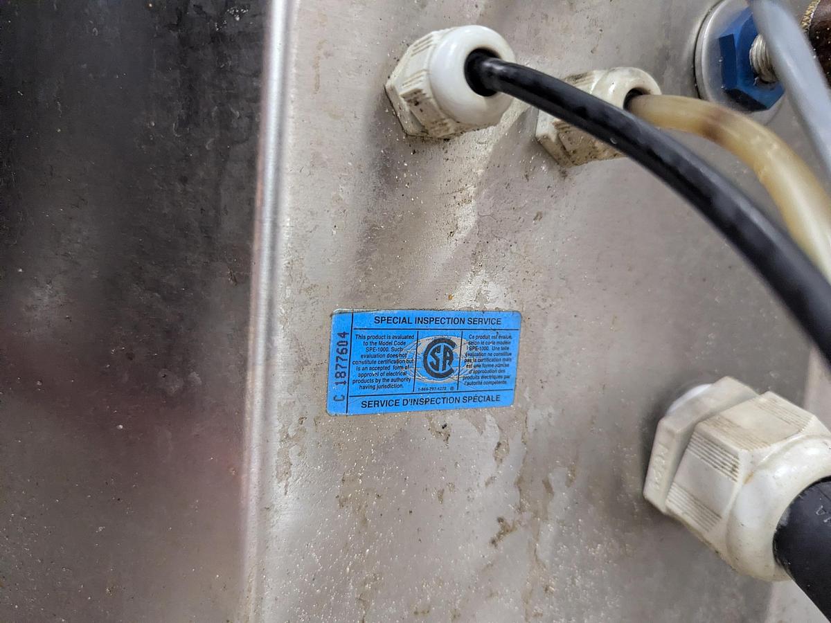 Used Aesus 6-Head Filling Line with Descrambler. Labeler, Filler, Capper, Induction Sealer & Accumulation Table