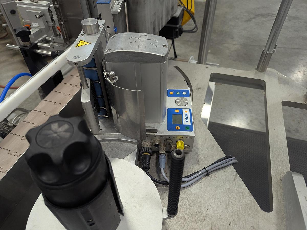 Used Aesus 6-Head Filling Line with Descrambler. Labeler, Filler, Capper, Induction Sealer & Accumulation Table