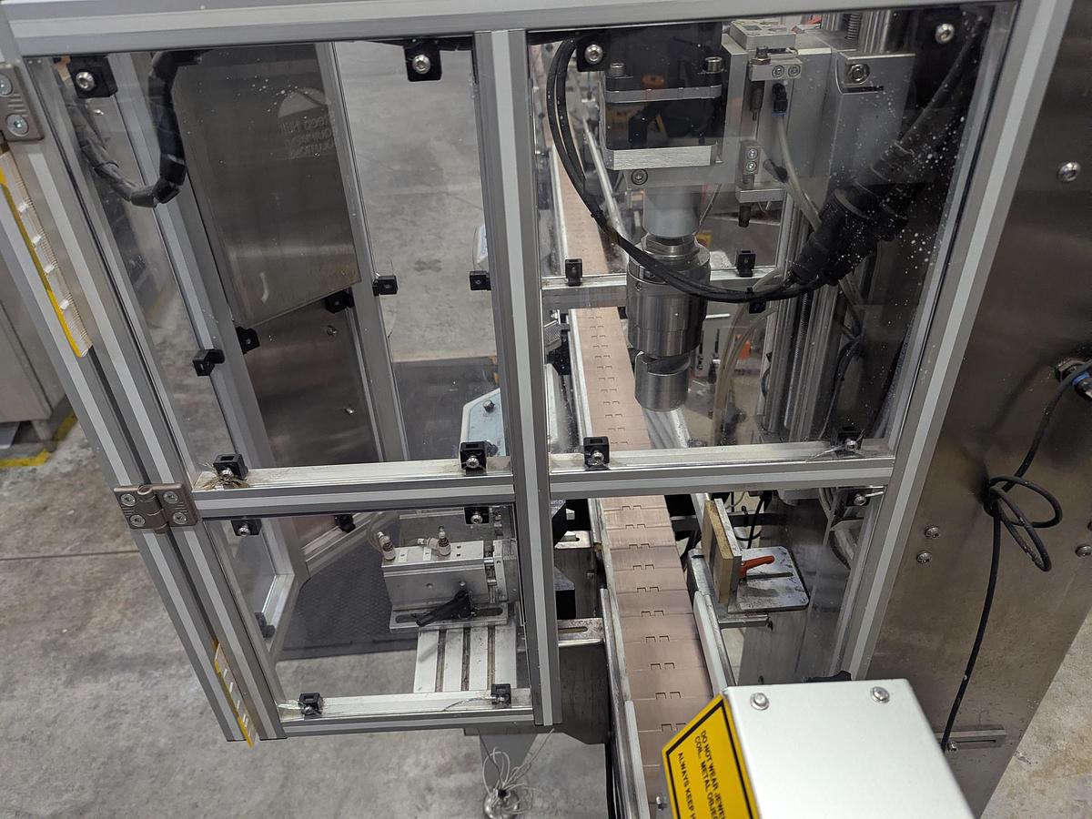 Used Aesus 6-Head Filling Line with Descrambler. Labeler, Filler, Capper, Induction Sealer & Accumulation Table