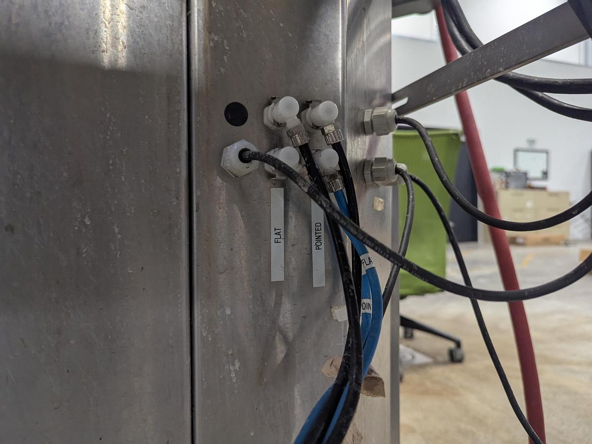 Used Aesus 6-Head Filling Line with Descrambler. Labeler, Filler, Capper, Induction Sealer & Accumulation Table