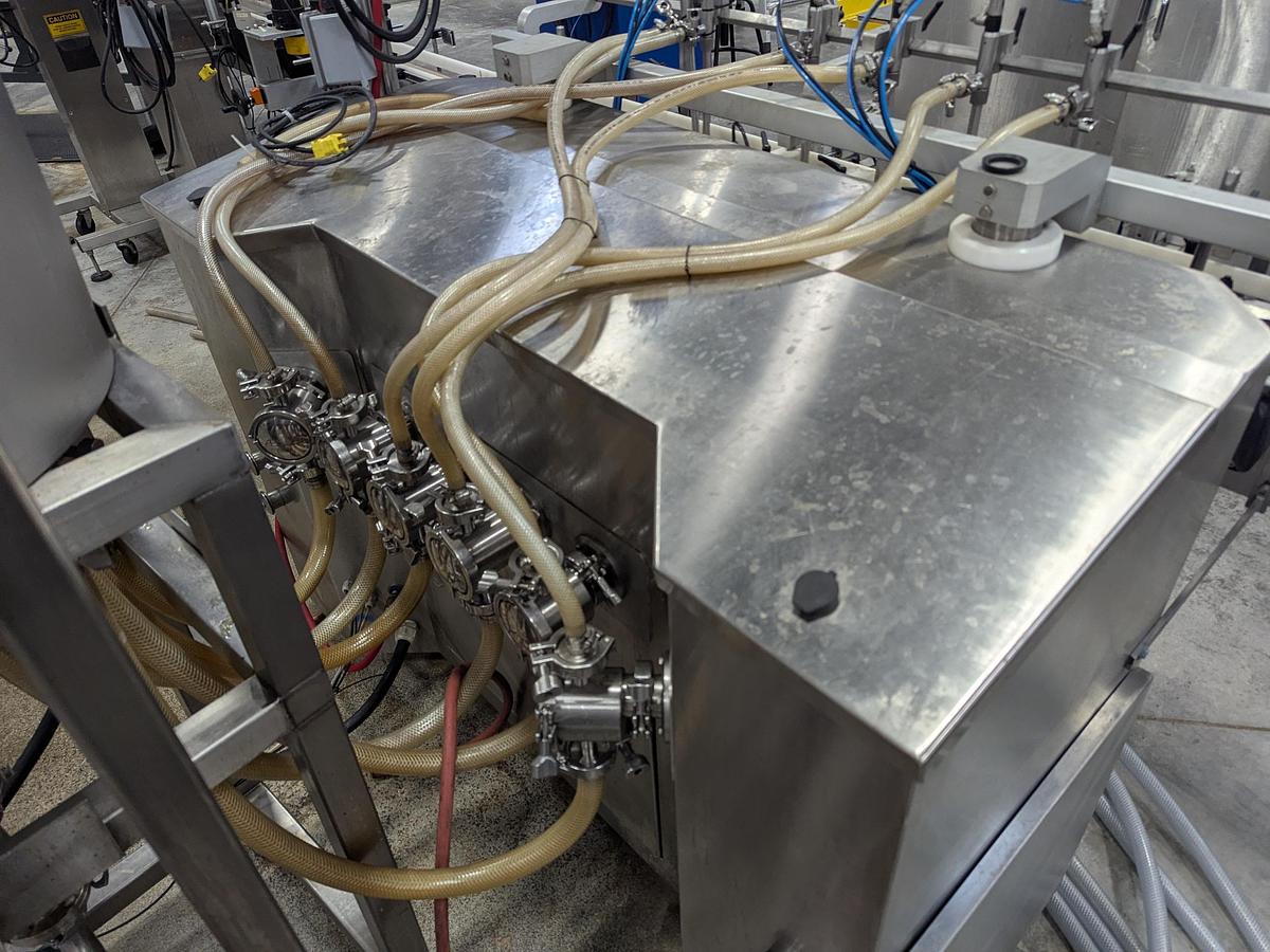 Used Aesus 6-Head Filling Line with Descrambler. Labeler, Filler, Capper, Induction Sealer & Accumulation Table