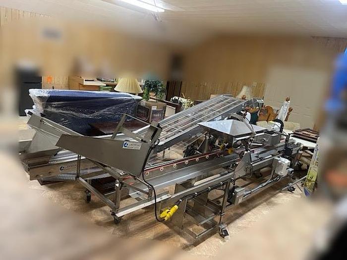 Used Lakewood Clamshell Filler with Infeed Conveyor & Accumulation Table