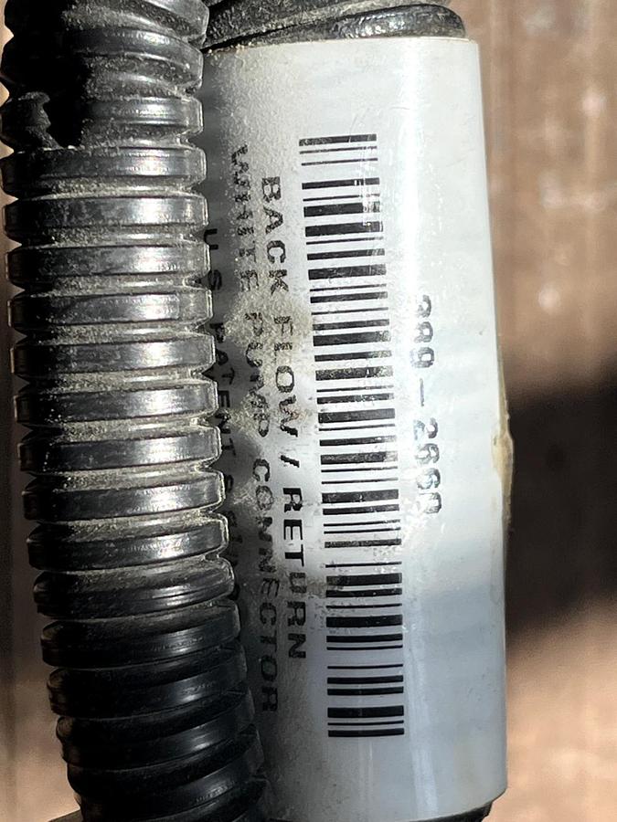 Used CAT Part # 506-5802.  BACK FLOW / RETURN WHITE PUMP CONNECTOR.  NEW.