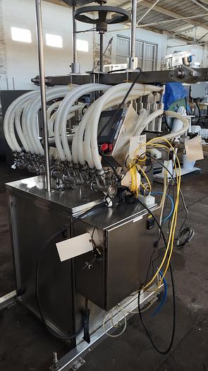Used Inline Filling Systems - inline 12 spout pressure gravity filler with conveyor