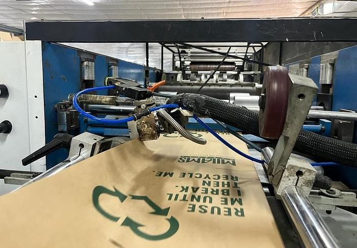 Used (visible in production) 1995 CURIONI SUN MASTER 540 - Reel fed Square bottom paper bag making machine with in line twisted handle unit