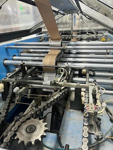 Used (visible in production) 1995 CURIONI SUN MASTER 540 - Reel fed Square bottom paper bag making machine with in line twisted handle unit