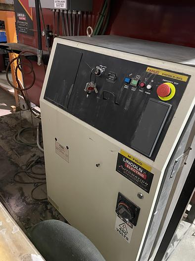 Used LINCOLN SYSTEM 55 WITH FANUC M710iC/20L TORCH CUTTING CELL WITH DUAL ROLL IN ROLL OUT TABLES