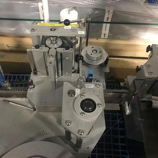 Used NJM Autocolt III - High Speed Pressure Sensitive Wraparound Labeler