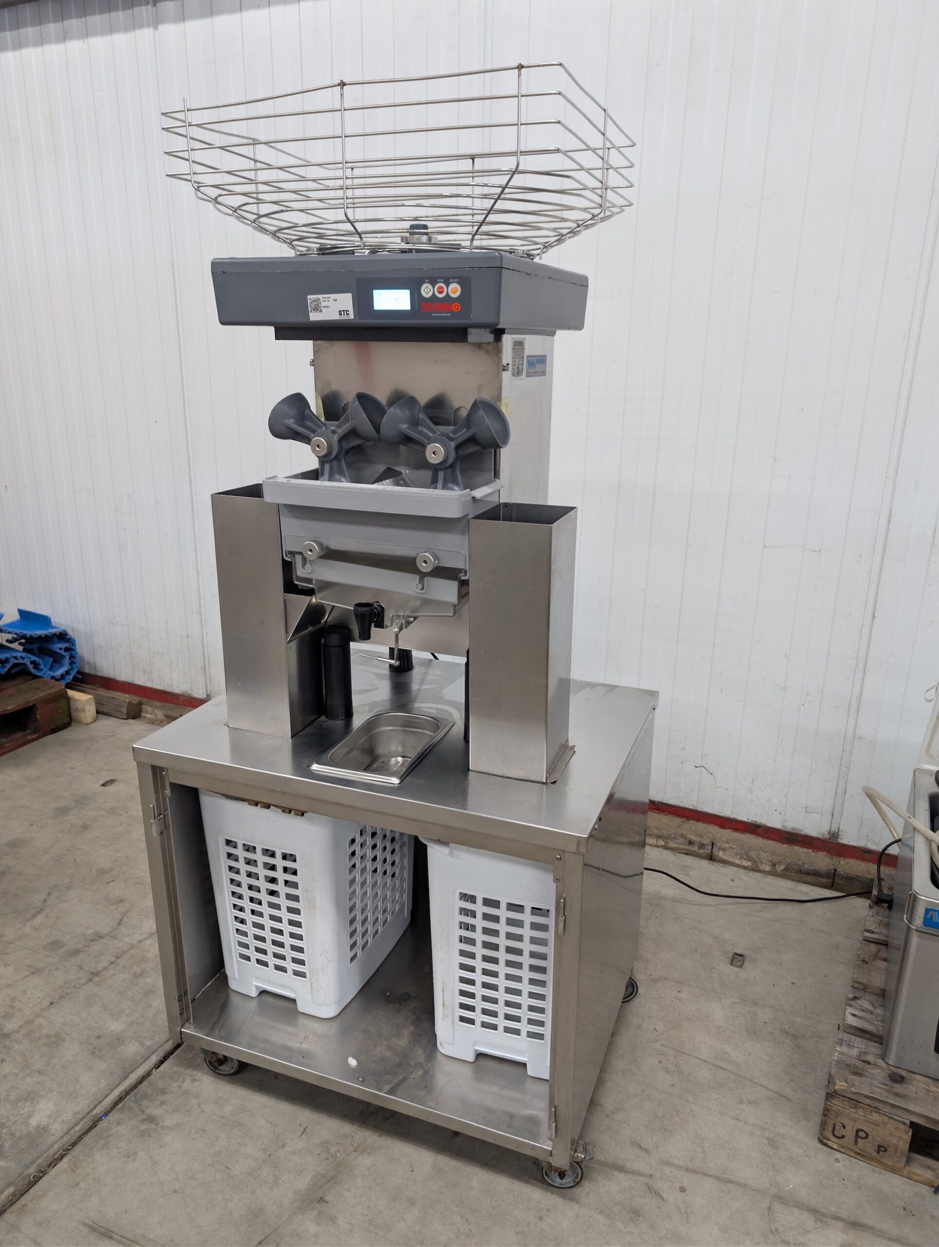 Used Zummo automatic orange juicer on stainless steel cabinet