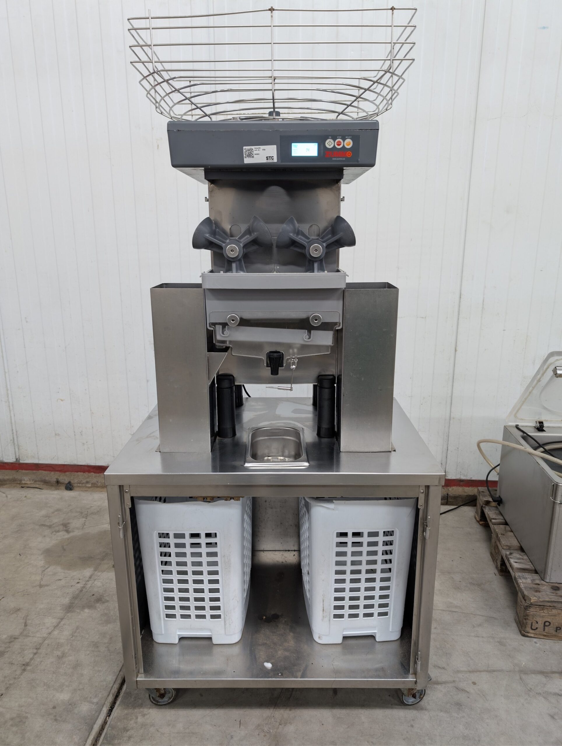 Used Zummo automatic orange juicer on stainless steel cabinet
