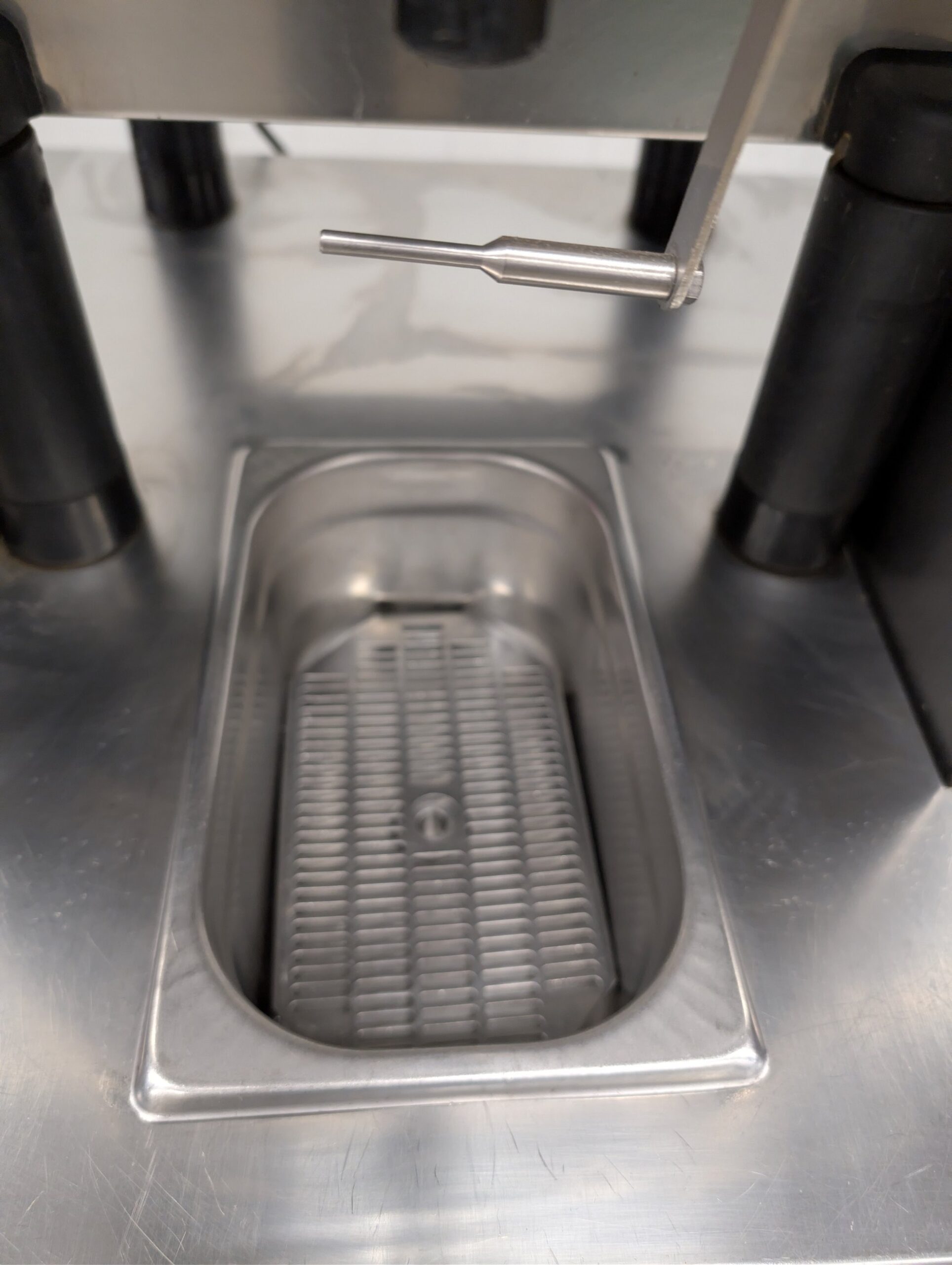 Used Zummo automatic orange juicer on stainless steel cabinet
