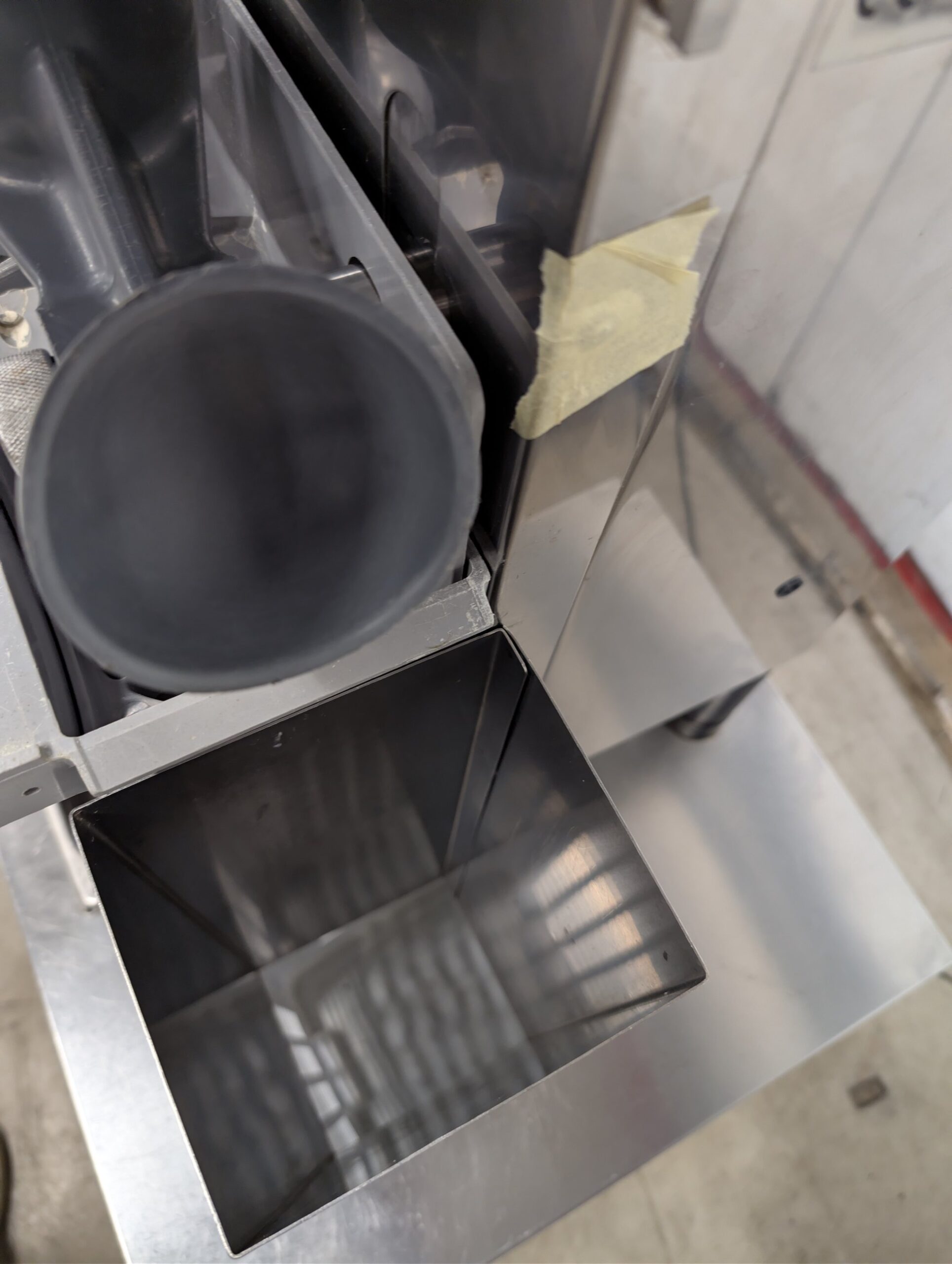 Used Zummo automatic orange juicer on stainless steel cabinet