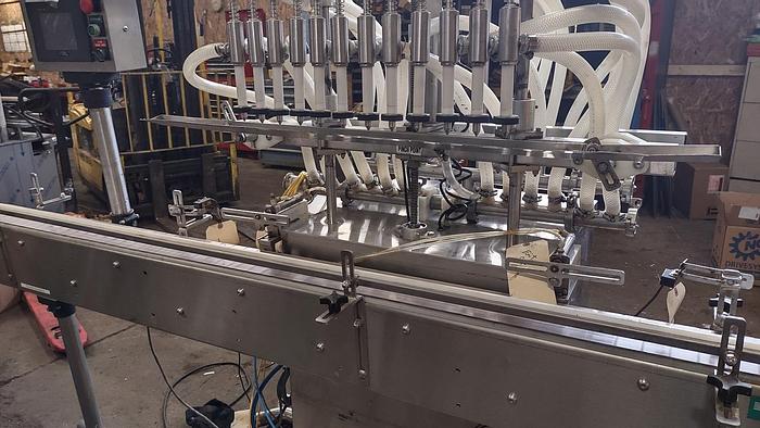 Used Inline Filling Systems - inline 12 spout pressure gravity filler with conveyor