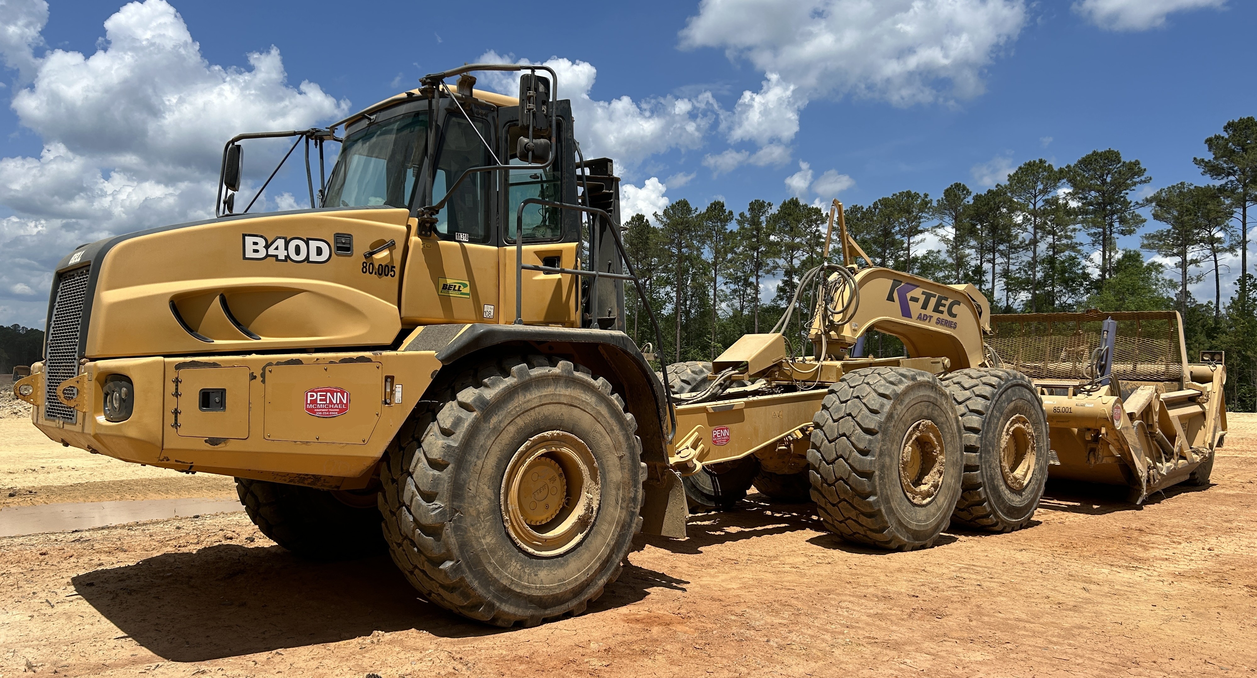 Used 2016 K-Tec K-Tec 1233 ADT scraper pulled by 2016 Bell B40D articulated dump truck