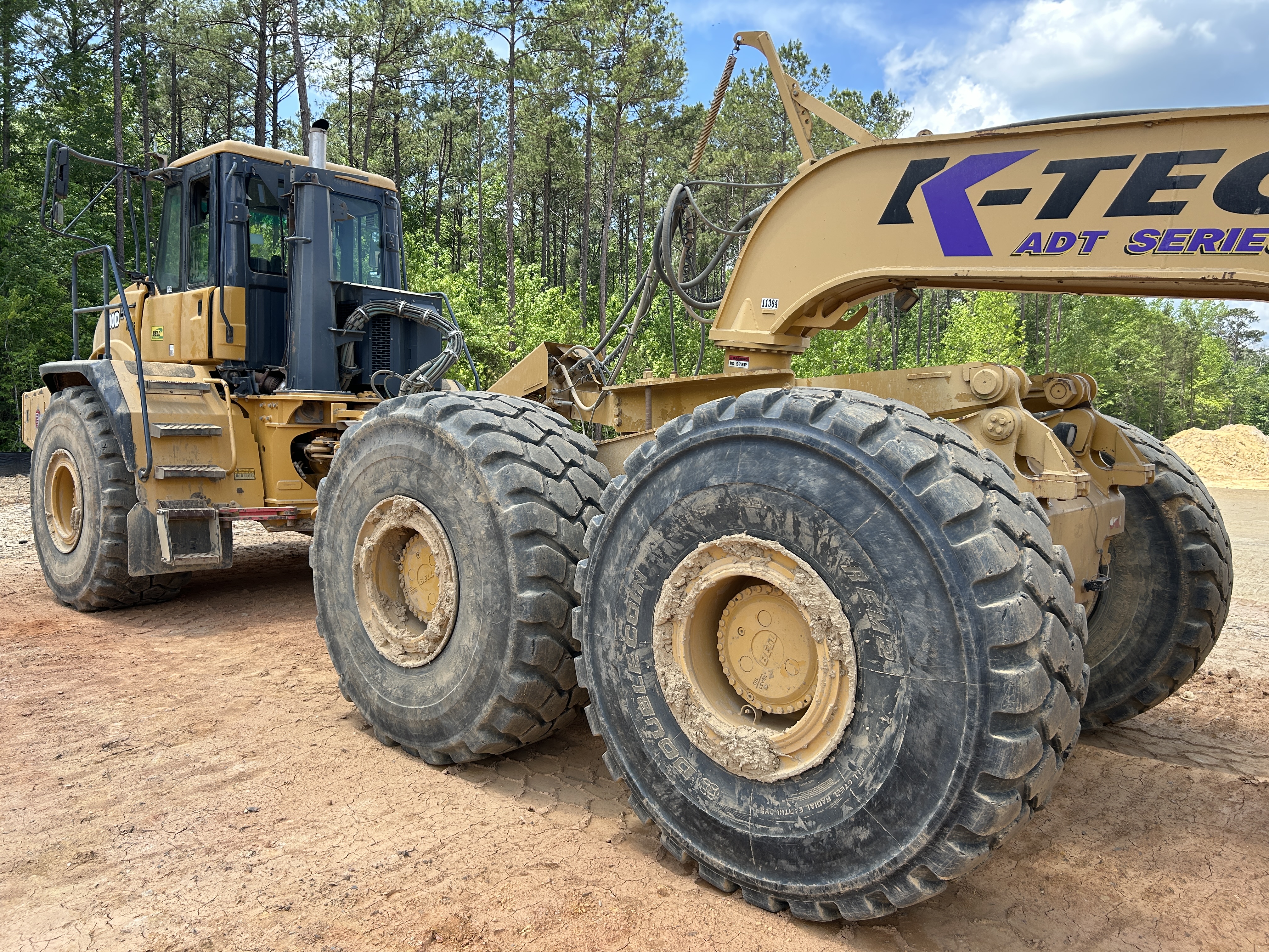 Used 2016 K-Tec K-Tec 1233 ADT scraper pulled by 2016 Bell B40D articulated dump truck