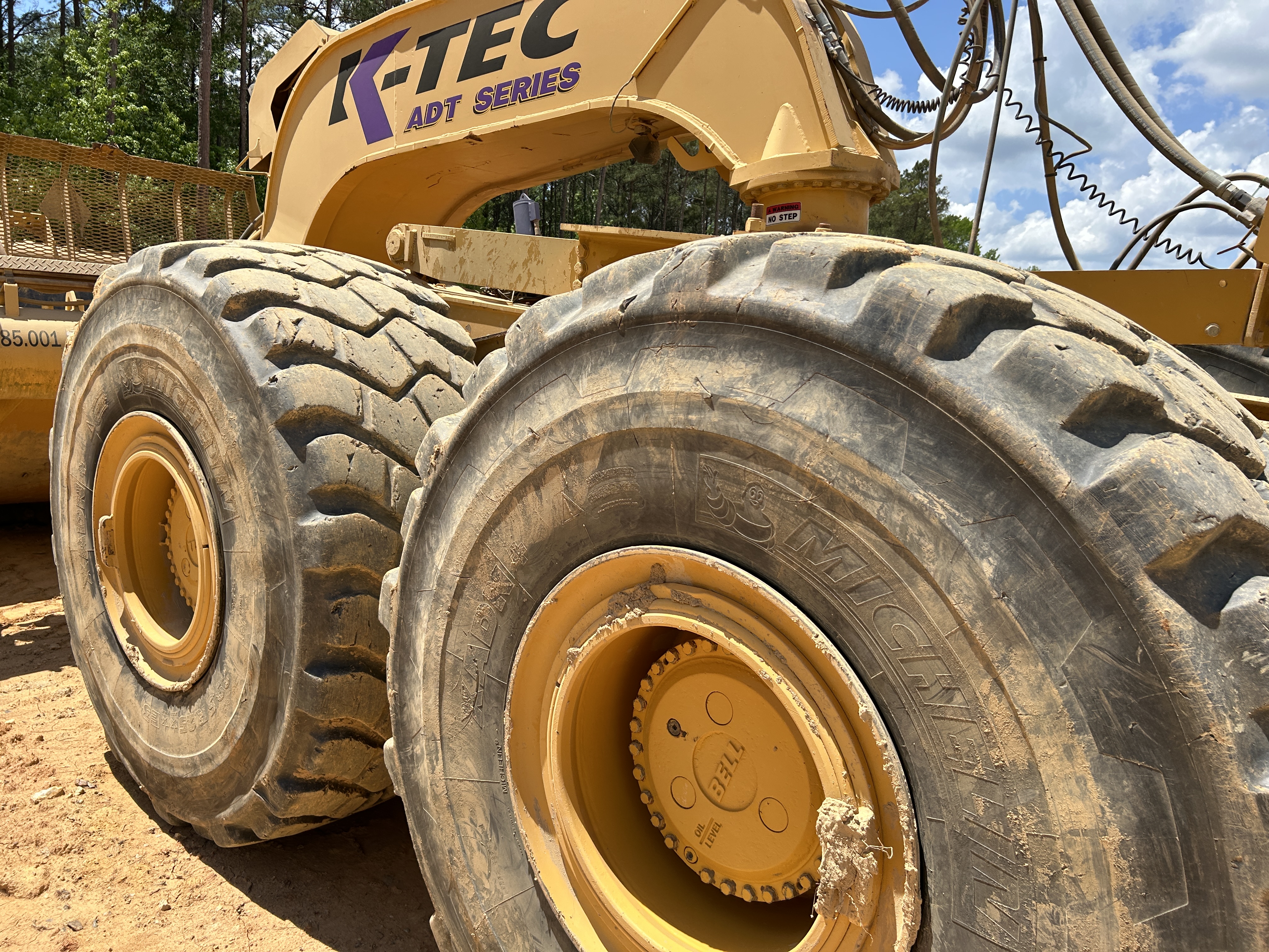 Used 2016 K-Tec K-Tec 1233 ADT scraper pulled by 2016 Bell B40D articulated dump truck