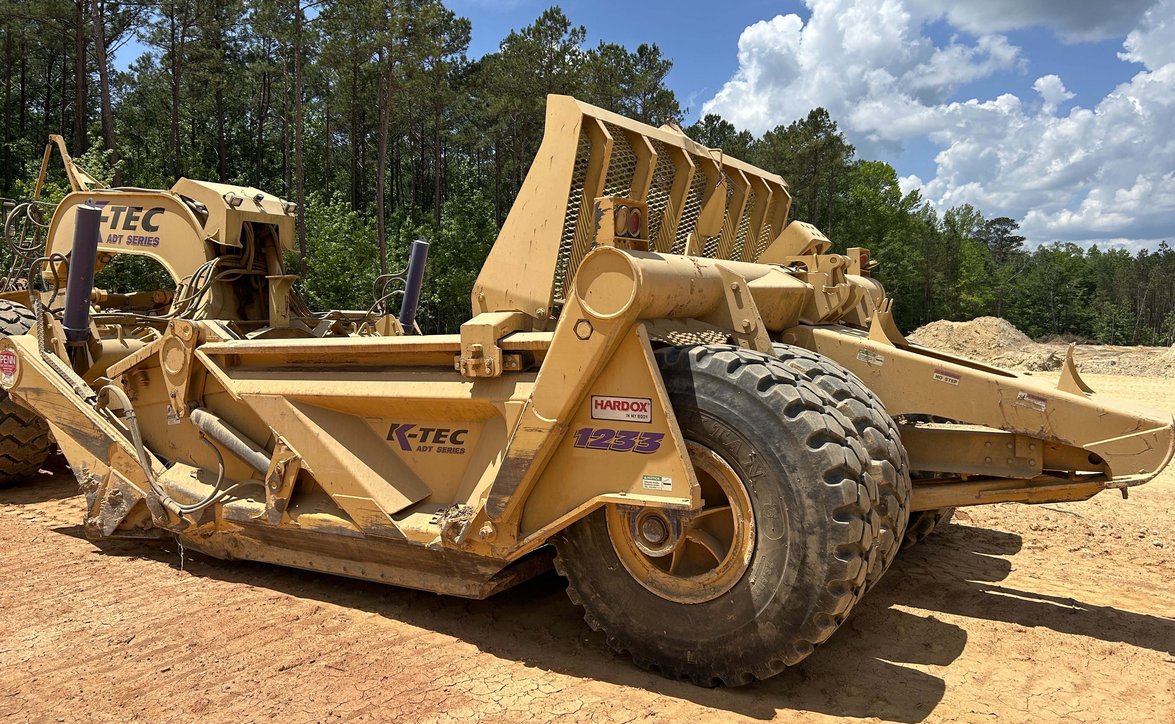 Used 2016 K-Tec K-Tec 1233 ADT scraper pulled by 2016 Bell B40D articulated dump truck