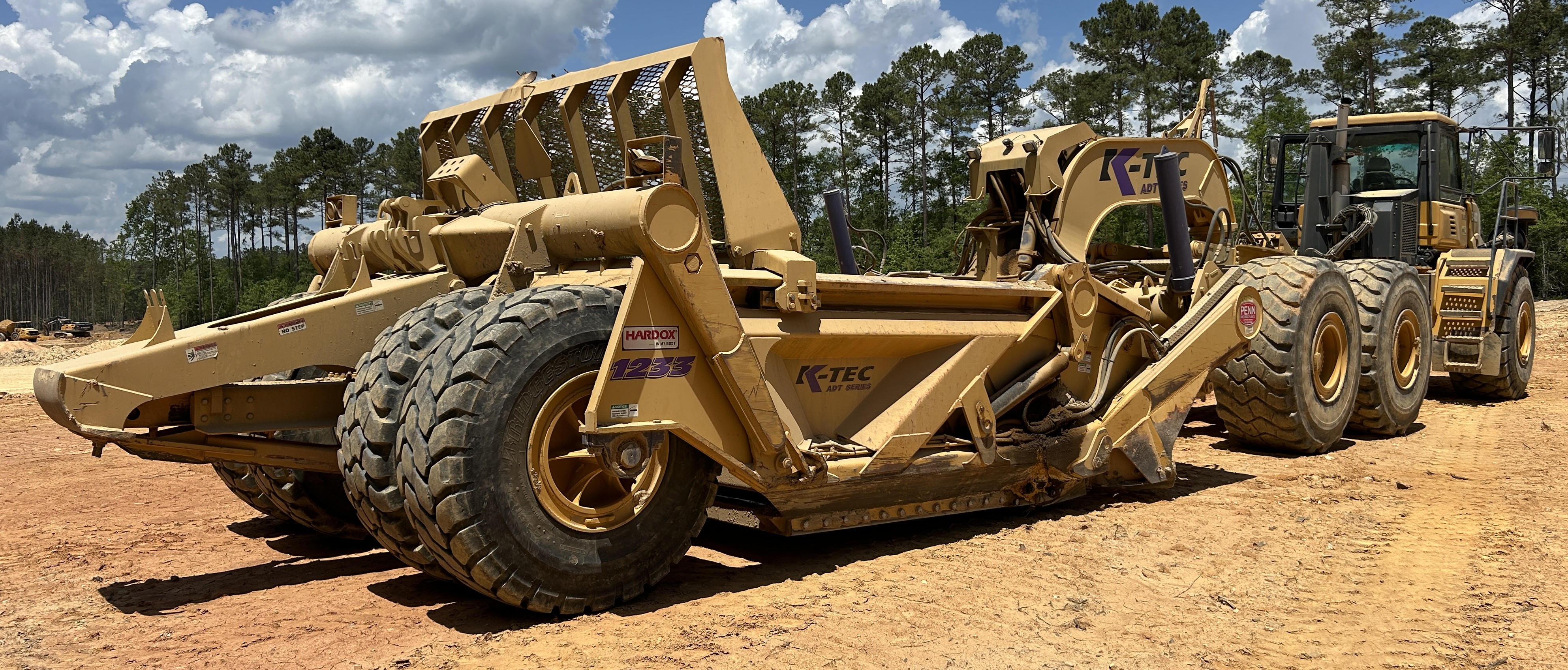 Used 2016 K-Tec K-Tec 1233 ADT scraper pulled by 2016 Bell B40D articulated dump truck