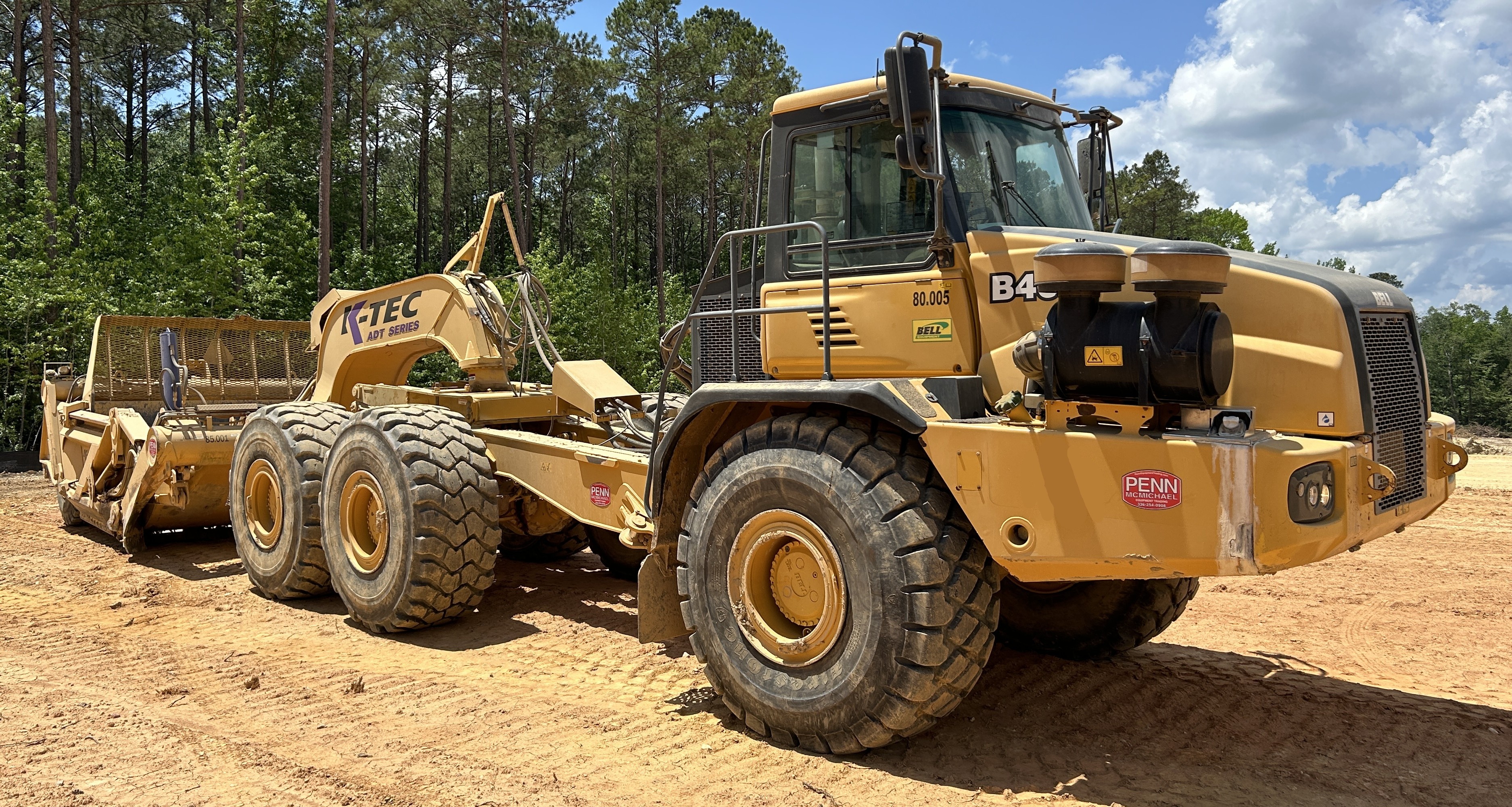 Used 2016 K-Tec K-Tec 1233 ADT scraper pulled by 2016 Bell B40D articulated dump truck