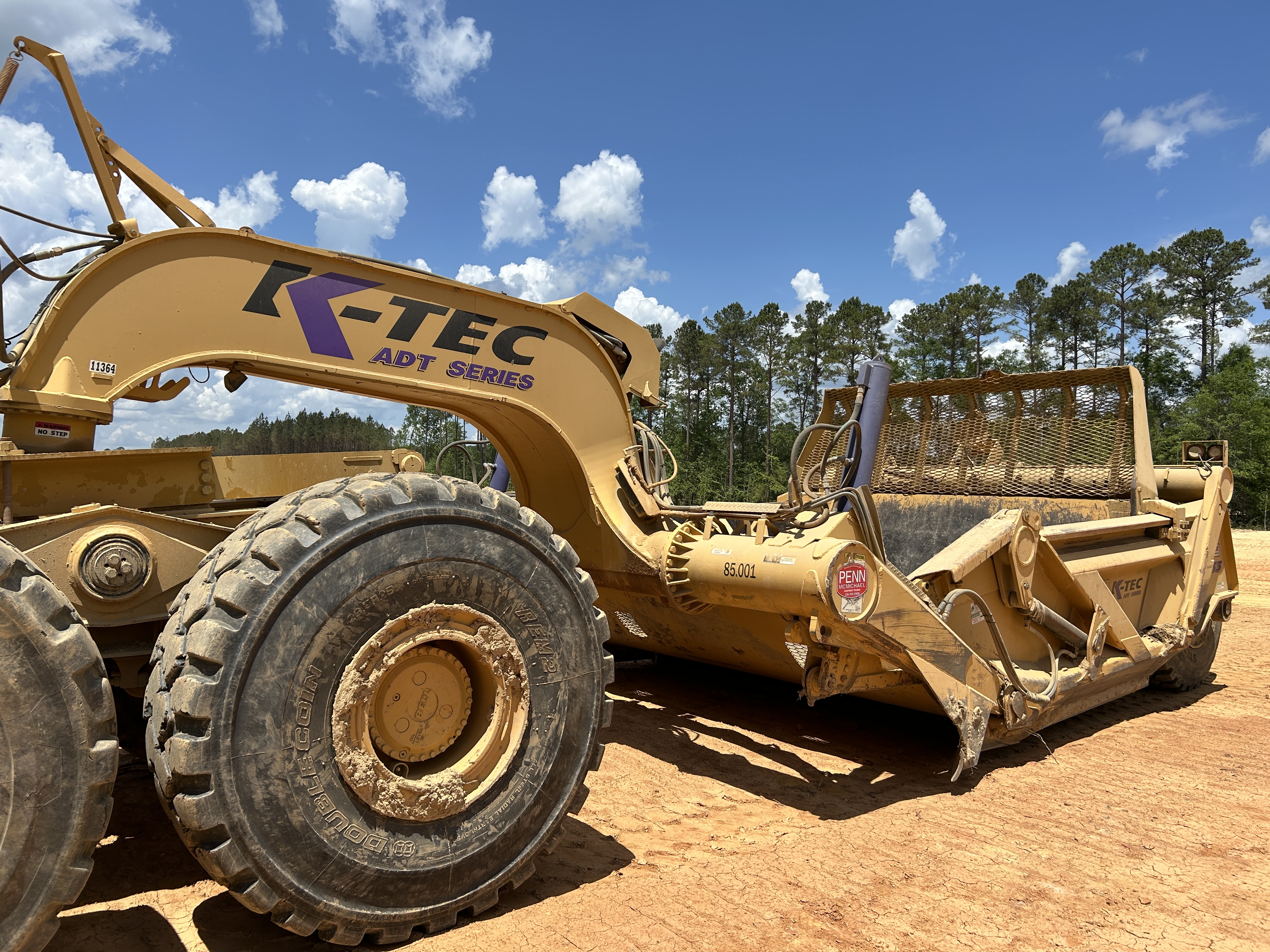 Used 2016 K-Tec K-Tec 1233 ADT scraper pulled by 2016 Bell B40D articulated dump truck