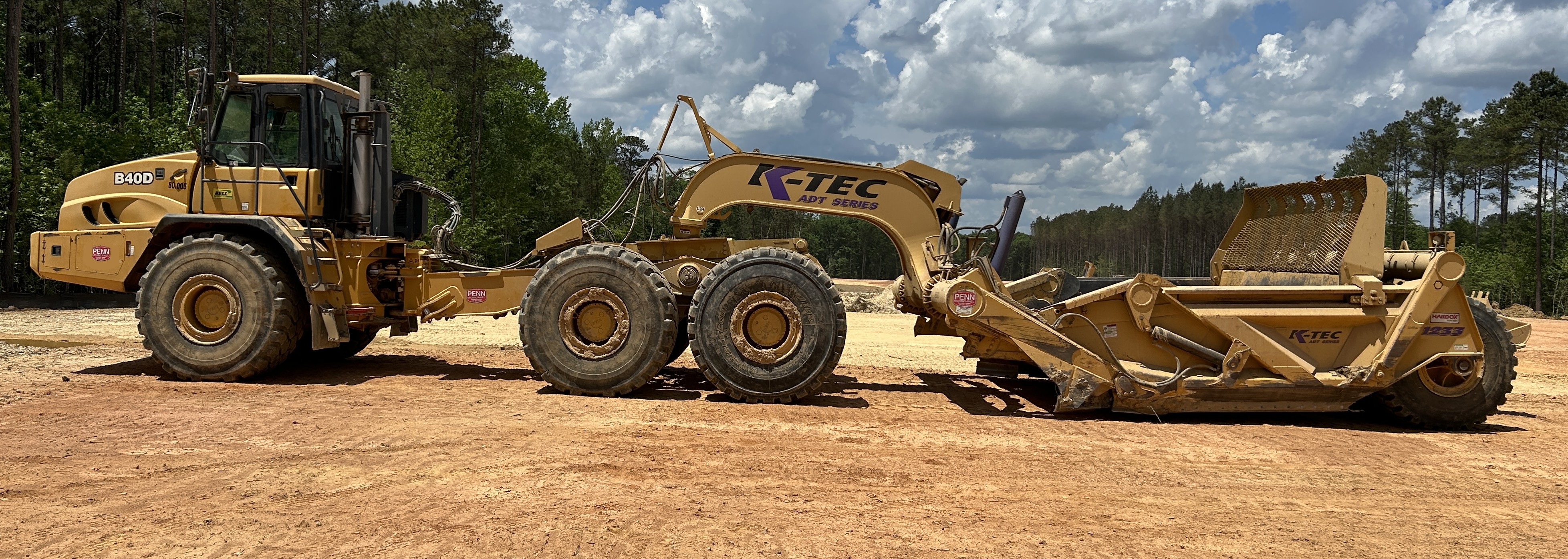 Used 2016 K-Tec K-Tec 1233 ADT scraper pulled by 2016 Bell B40D articulated dump truck
