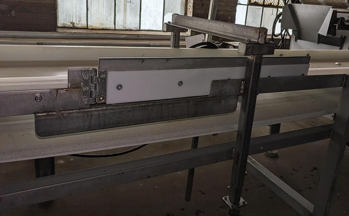 Used conveyor, stainless steel frame, 18" wide 21' long PVC belt adjustable leg with casters.
