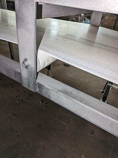 Used conveyor, stainless steel frame, 18" wide 21' long PVC belt adjustable leg with casters.
