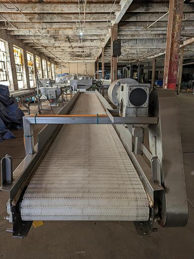Used conveyor, stainless steel frame, 19" wide 20' long plastic modular belt adjustable leg with casters.