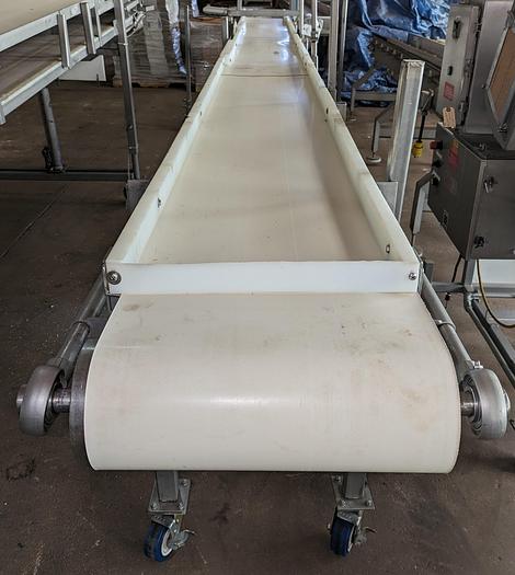 Used conveyor, stainless steel frame, 18" wide 21' long PVC belt adjustable leg with casters.
