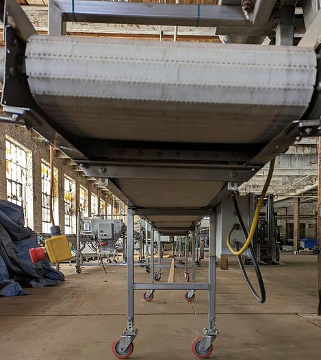 Used conveyor, stainless steel frame, 19" wide 20' long plastic modular belt adjustable leg with casters.