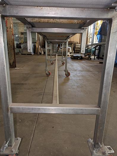 Used conveyor, stainless steel frame, 19" wide 20' long plastic modular belt adjustable leg with casters.