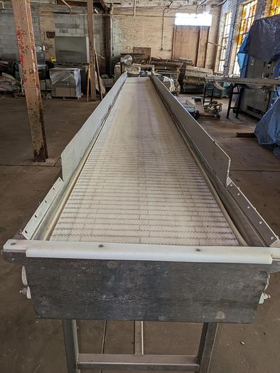 Used conveyor, stainless steel frame, 19" wide 20' long plastic modular belt adjustable leg with casters.