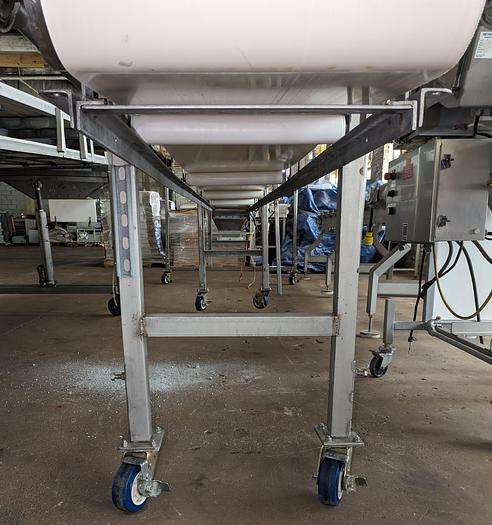 Used conveyor, stainless steel frame, 18" wide 21' long PVC belt adjustable leg with casters.