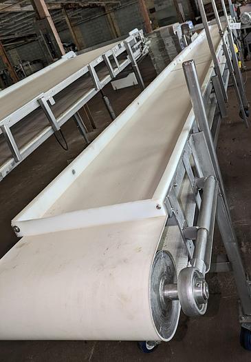 Used conveyor, stainless steel frame, 18" wide 21' long PVC belt adjustable leg with casters.
