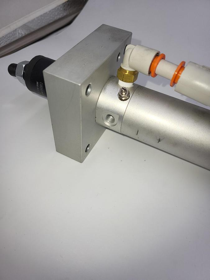 Used SMC NCDGBA32-1300 Round Body Cylinder: 1 1/4 in Bore, 16 in Stroke & floating joint SMC 3G1-44C / 3" mounting plate