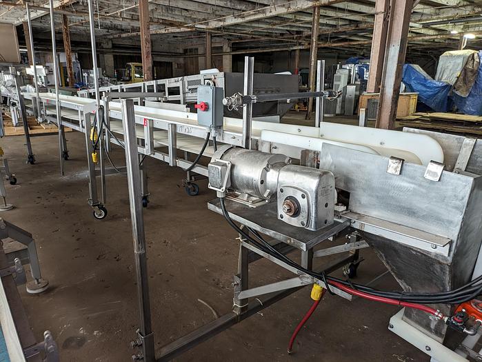 Used conveyor, stainless steel frame, 18" wide 21' long PVC belt adjustable leg with casters.