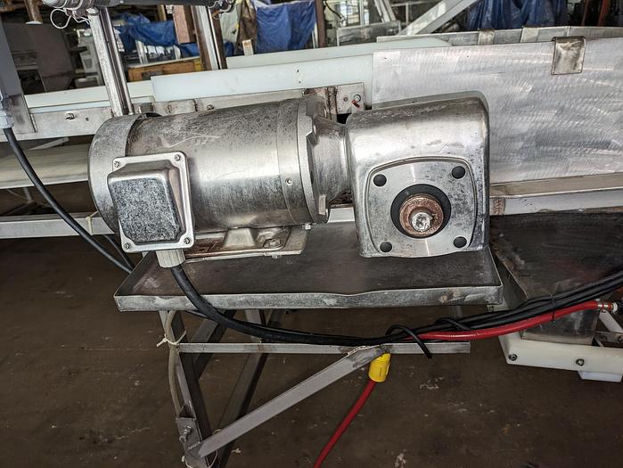 Used conveyor, stainless steel frame, 18" wide 21' long PVC belt adjustable leg with casters.