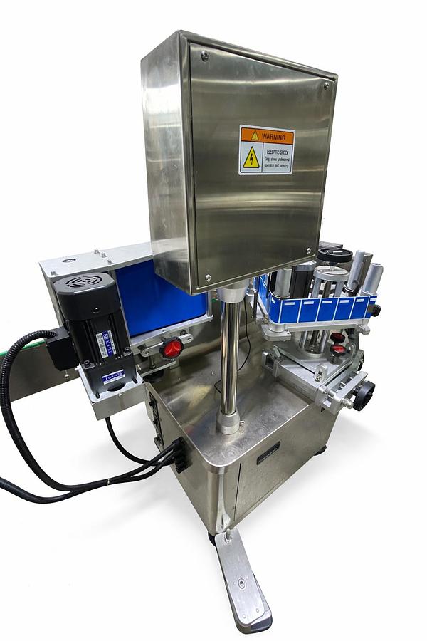 Used AUTOMATIC LABELING MACHINE FOR ROUND BOTTLES  PLC System  Touch Screen control panel  Labels up to 6.5" high-READY FOR SHIPMENT