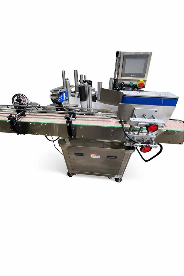 Used AUTOMATIC LABELING MACHINE FOR ROUND BOTTLES  PLC System  Touch Screen control panel  Labels up to 6.5" high-READY FOR SHIPMENT