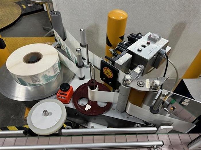 Used CVC model 300 wraparound pressure sensitive labeler with 28" accumulating table