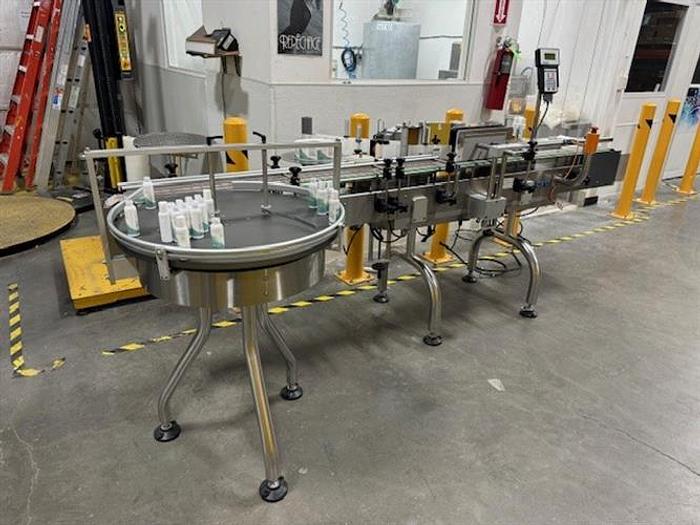 Used CVC model 300 wraparound pressure sensitive labeler with 28" accumulating table