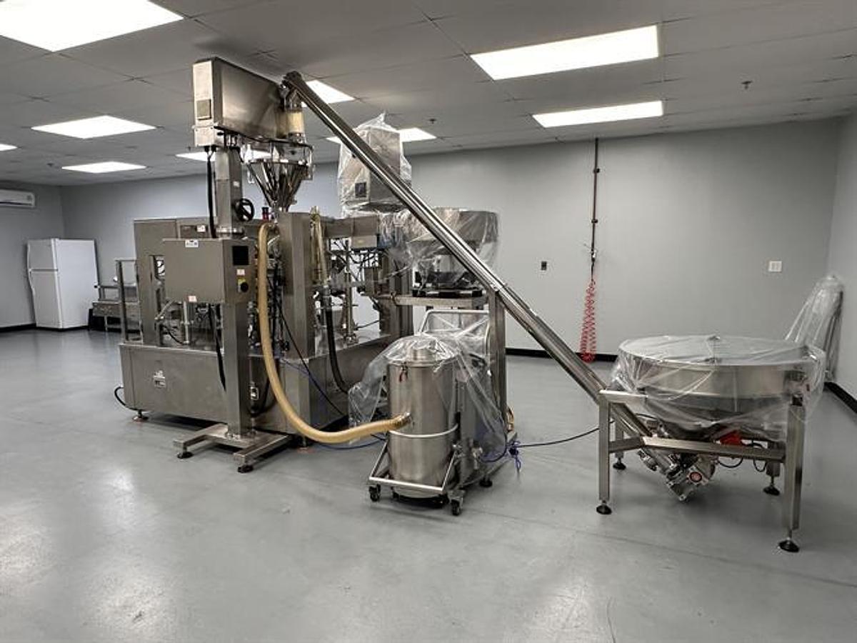 Used New Genesis Pre-Made Rotary Bagger With Auger Filler And Desiccant & Pouch Feeders