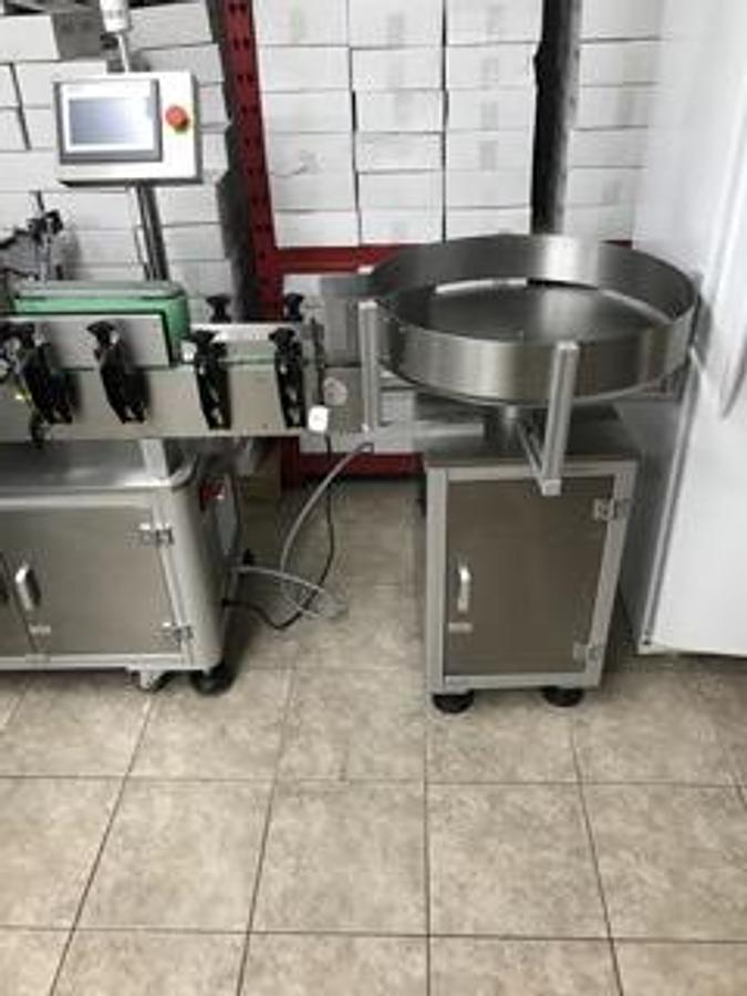 Used Saturn LAWA-A Wraparound Labeler with Accumulating Table