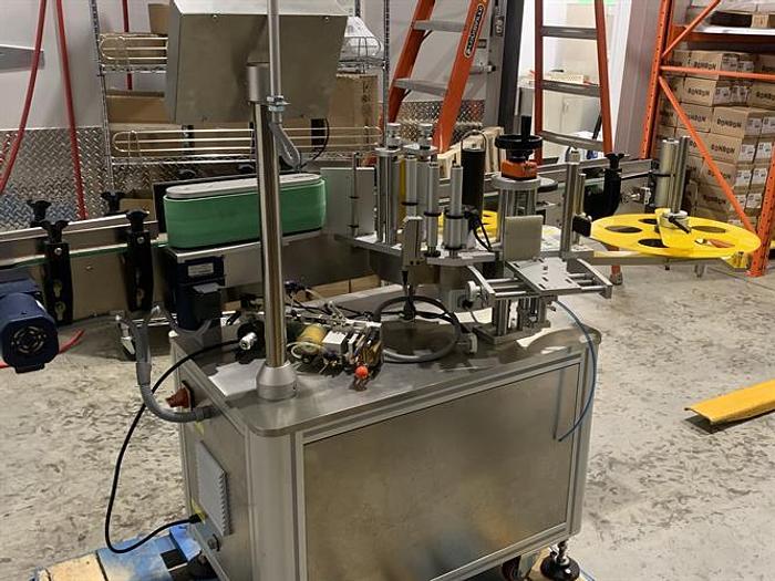 Used Saturn LAWA-A Wraparound Labeler with Accumulating Table