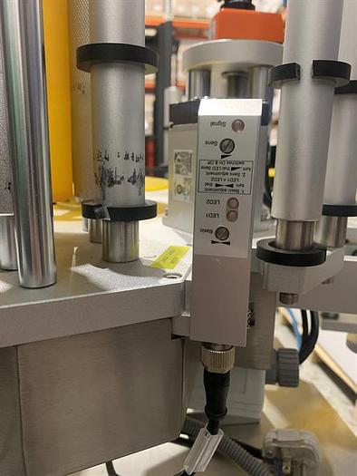 Used Saturn LAWA-A Wraparound Labeler with Accumulating Table