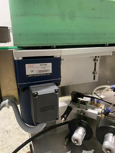 Used Saturn LAWA-A Wraparound Labeler with Accumulating Table